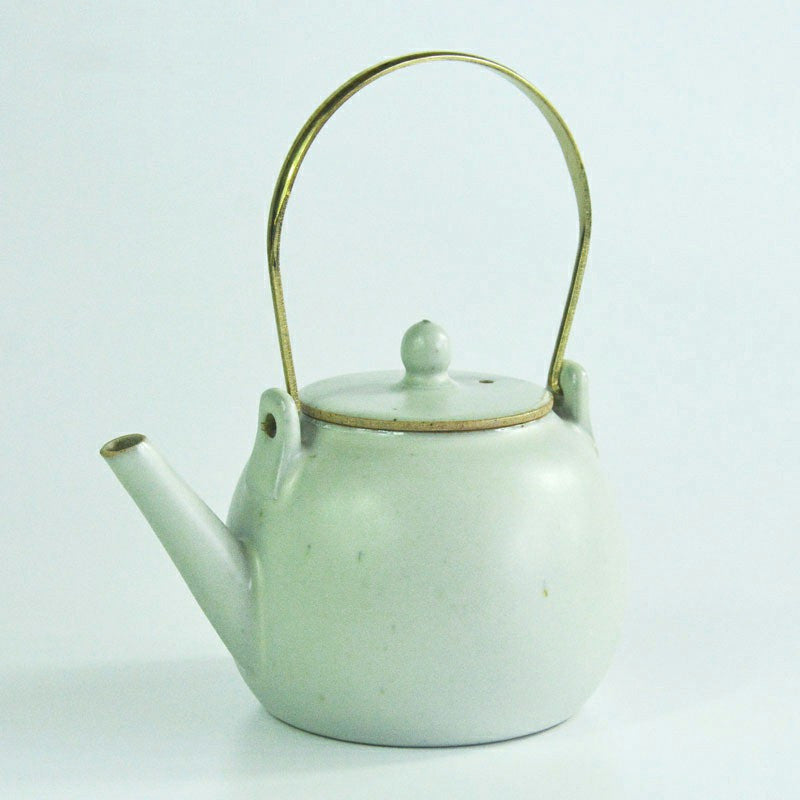 Huayue Ceramic Teapot — Pale ceramic teapot with an arched handle.
