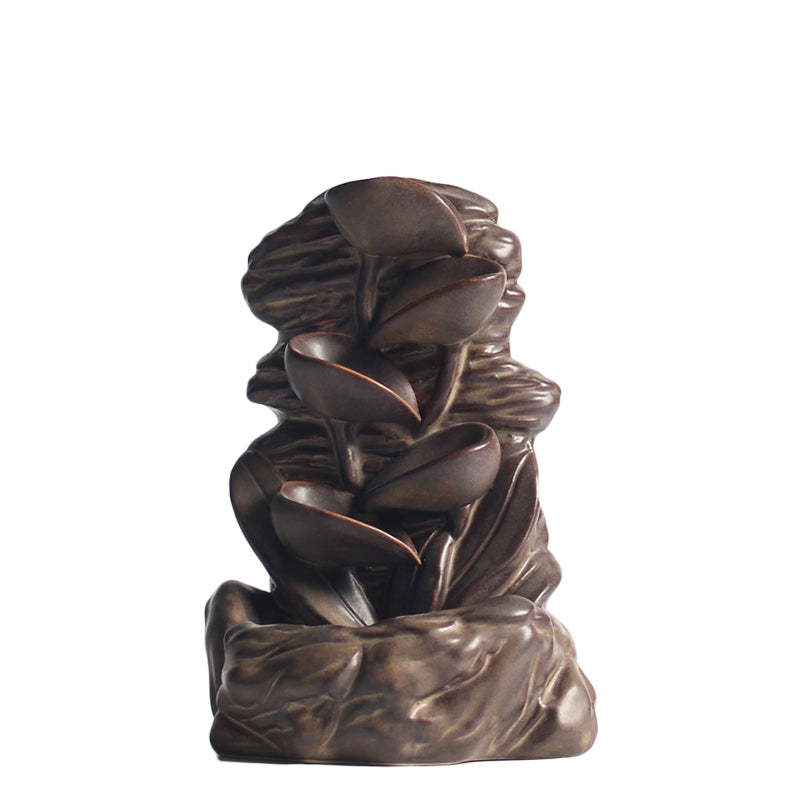 Misool Incense Burner — Brown ceramic rock-and-waterfall incense burner.