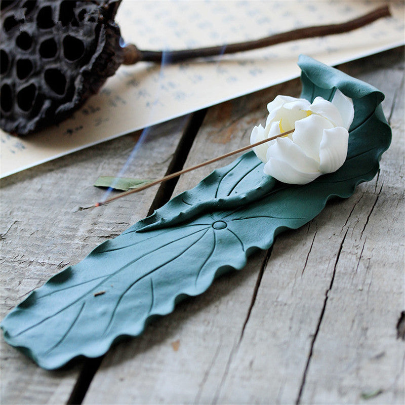 Belitung Incense Burner — Green leaf-shaped porcelain incense plate with a lotus detail.