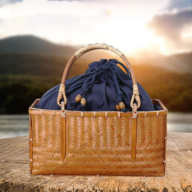 Hida Tea Storage Basket — Rectangular woven tea basket with a navy fabric bag.