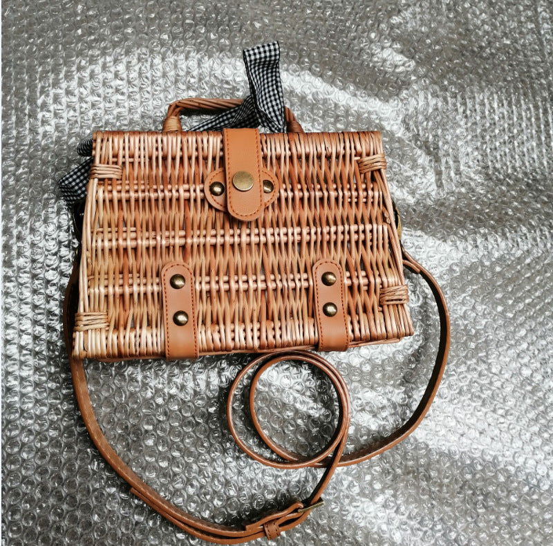 Kakaban Square Woven Handbag — Square woven basket bag with short handles and a shoulder strap.