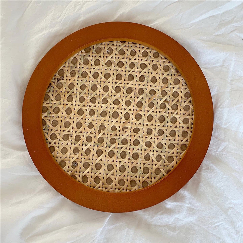 Tidore Serving Tray — Round tray with a warm-toned frame and woven inset.