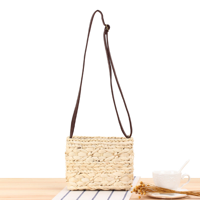 Seseh Woven Crossbody Bag — Beige rectangular corn-husk woven crossbody bag.