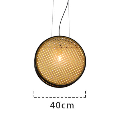 Lestari Rattan Pendant Light — Circular woven pendant shade with a black rim and metal frame.