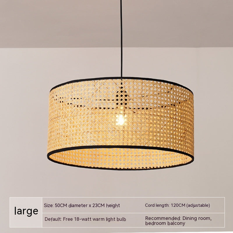 Seroja Rattan Pendant Light — Wide cylindrical woven pendant shade with a dark rim.
