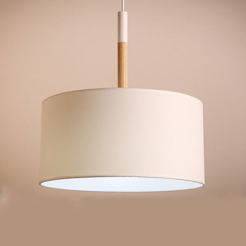 Purwokerto Pendant Light — Cream drum pendant shade with a wooden stem.