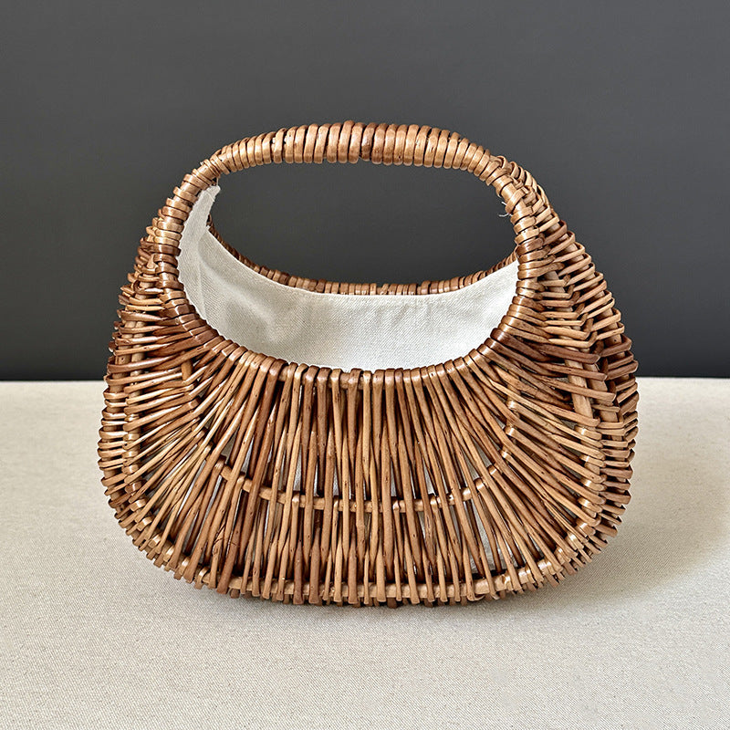 Kasumi Woven Handbag — Open-weave curved handbag with an oval handle.
