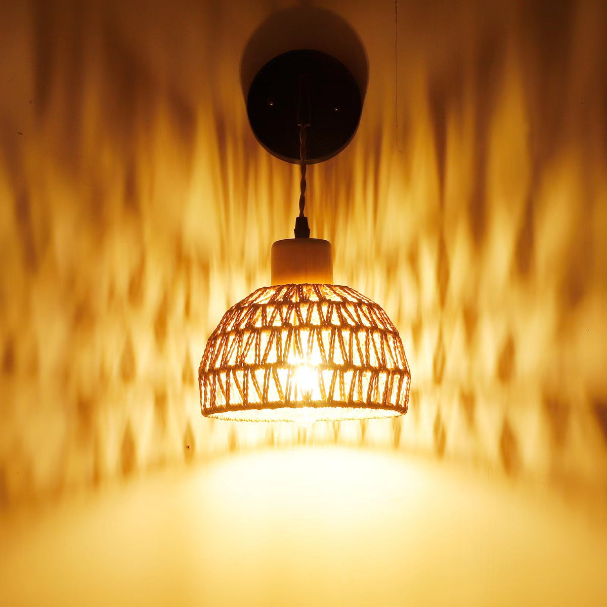 Ganzhou Wall Light — Woven bell-shaped wall-light shade on a dark mounting arm.