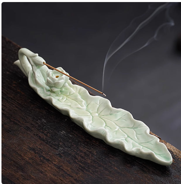 Ishigaki Incense Holder — Long celadon ceramic leaf-shaped incense holder with a lotus detail.