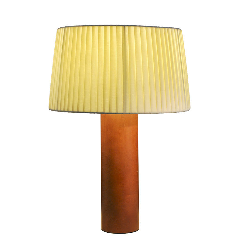 Momiji Solid Wood Table Lamp — Wooden cylindrical lamp base with a pleated beige shade.
