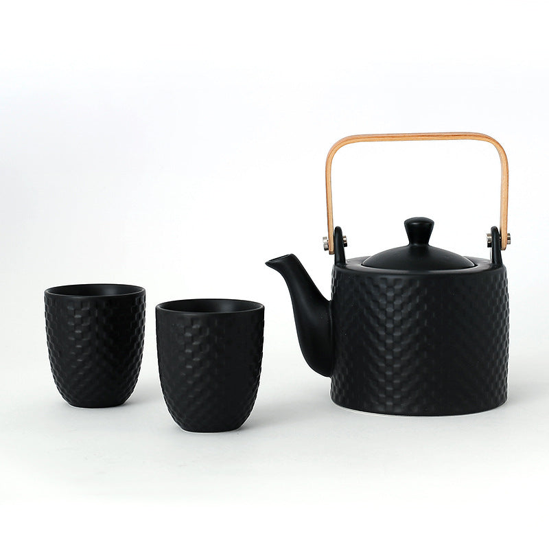 Sipora Tea Set — Black ceramic teapot with two matching cups.