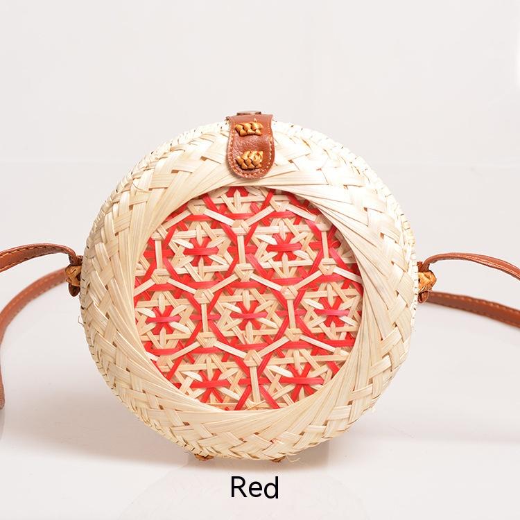 Daisen Woven Handbag — Round red woven handbag with a floral detail.