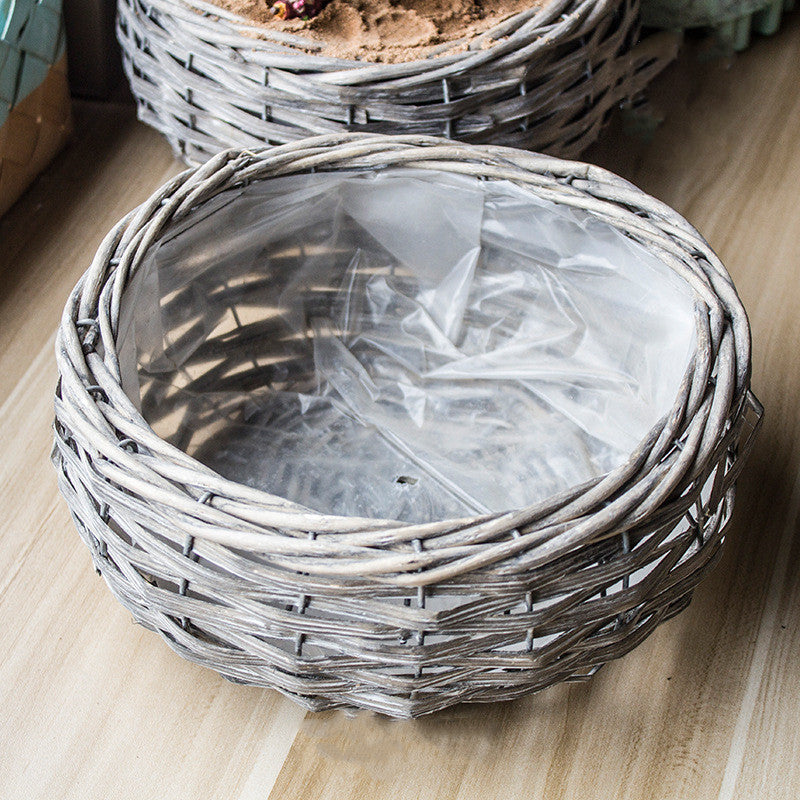 Aki Storage Basket — Round woven planter basket with a pale washed finish.