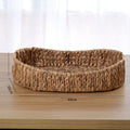 Buton Storage Basket — Oval woven basket with a low rim.