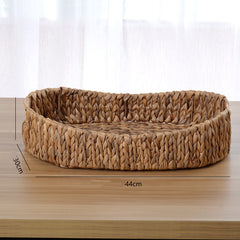 Buton Storage Basket — Oval woven basket with a low rim.