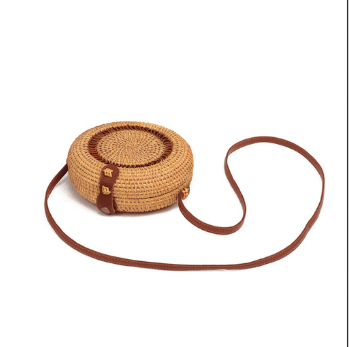 Magelang Woven Handbag — Round woven crossbody bag with a shoulder strap.