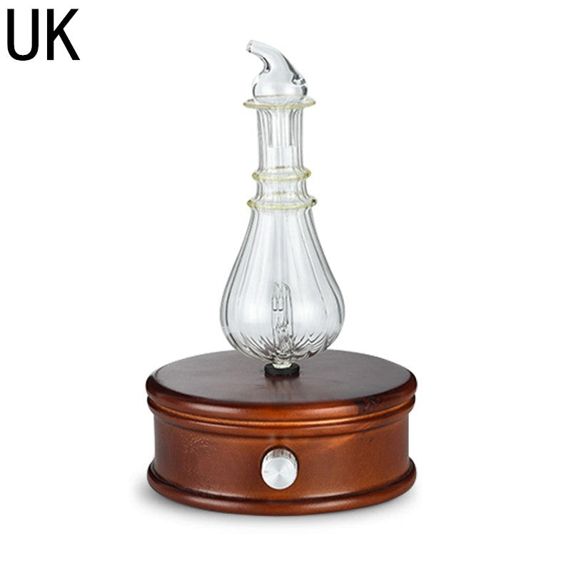 Surya Wood and Glass Aroma Diffuser — Round tiered wooden diffuser base with a glass bottle, in the UK configuration.