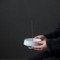 Kudus Incense Holder — White circular ceramic incense holder with an off-centre opening.