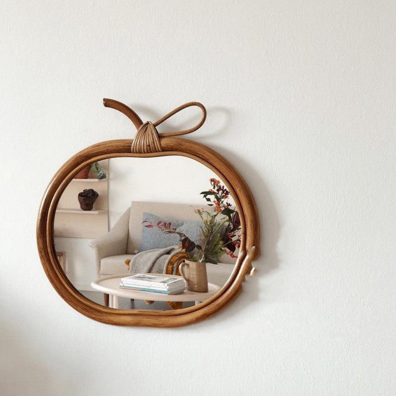 Madura Decorative Mirror — Round woven mirror frame with a bow-shaped detail.