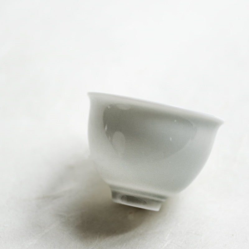 Meno Tea Cup — Pale porcelain tea cup with a raised foot.